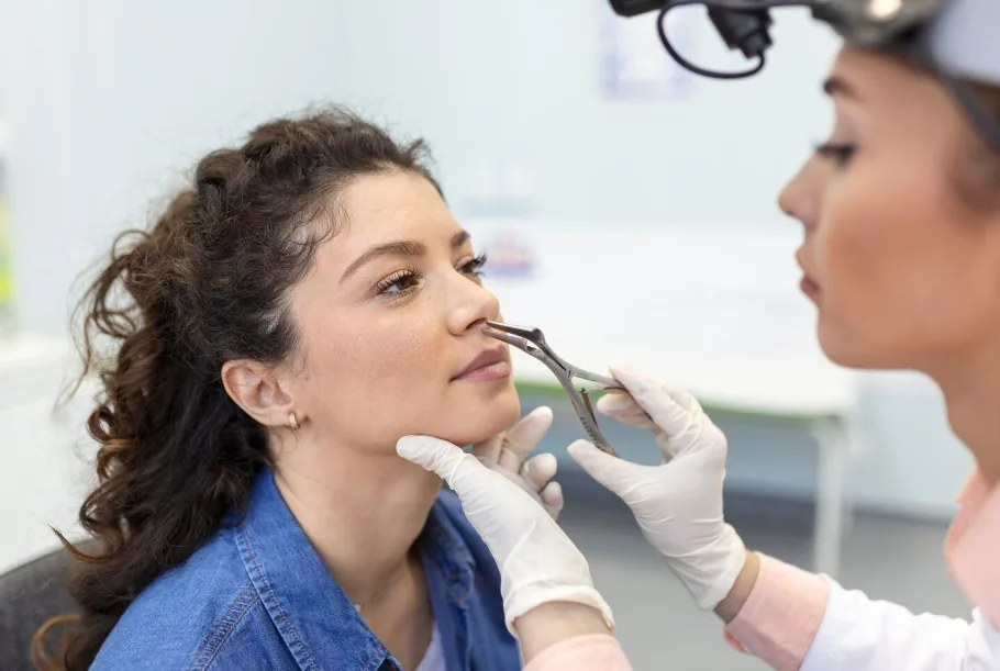 Specialist performing a thorough nasal examination before safe nose filler treatment in Dubai