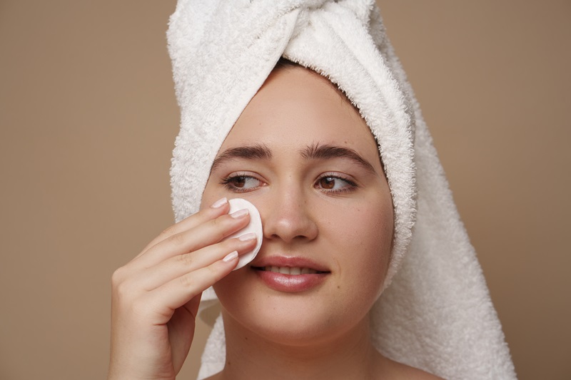 Gentle facial exfoliation with a soft skincare pad